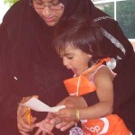 Mother and daughter create a craft during Arab Festival